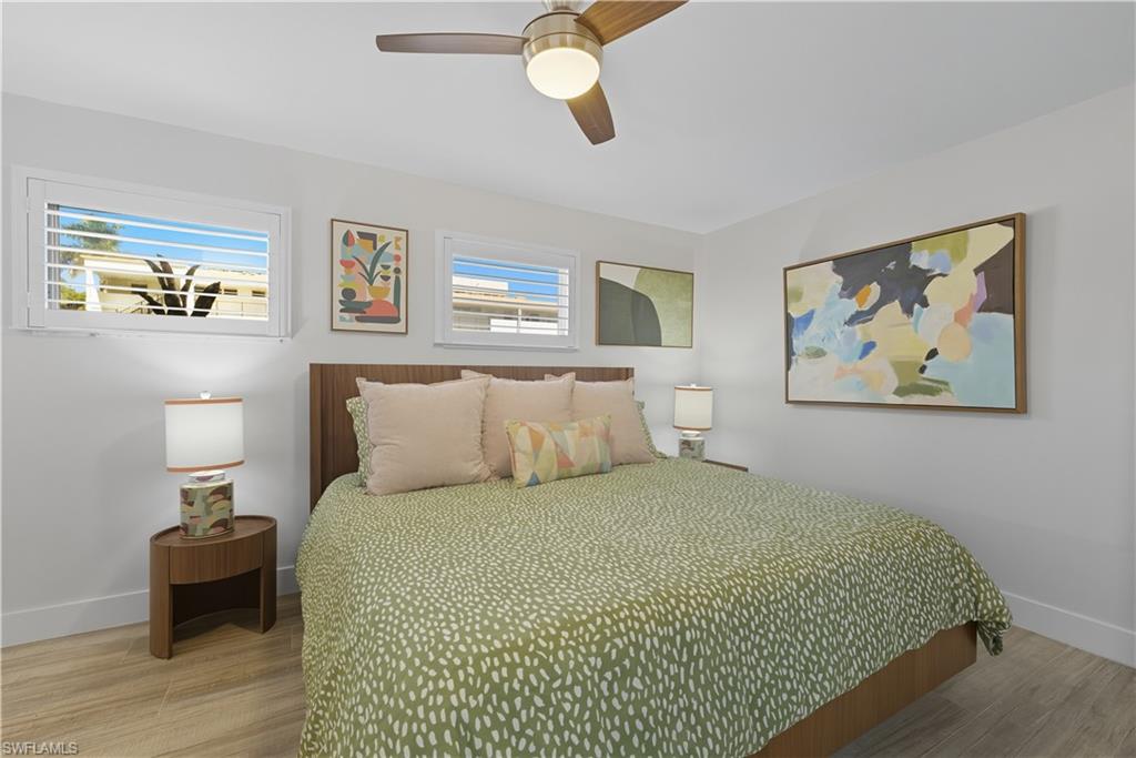 Bedroom with light wood finished floors and ceiling fan