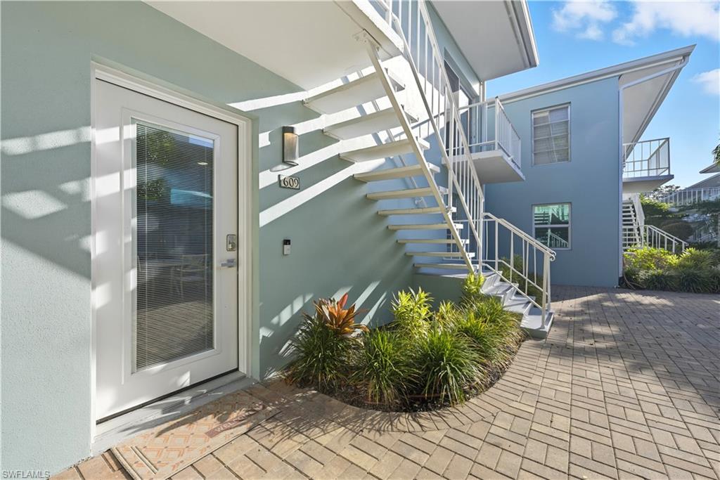 Entrance to property with stucco siding
