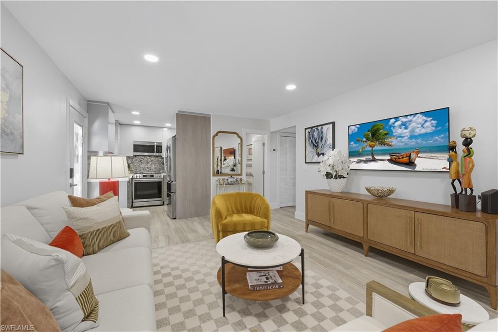 Living area featuring light wood-style flooring and recessed lighting