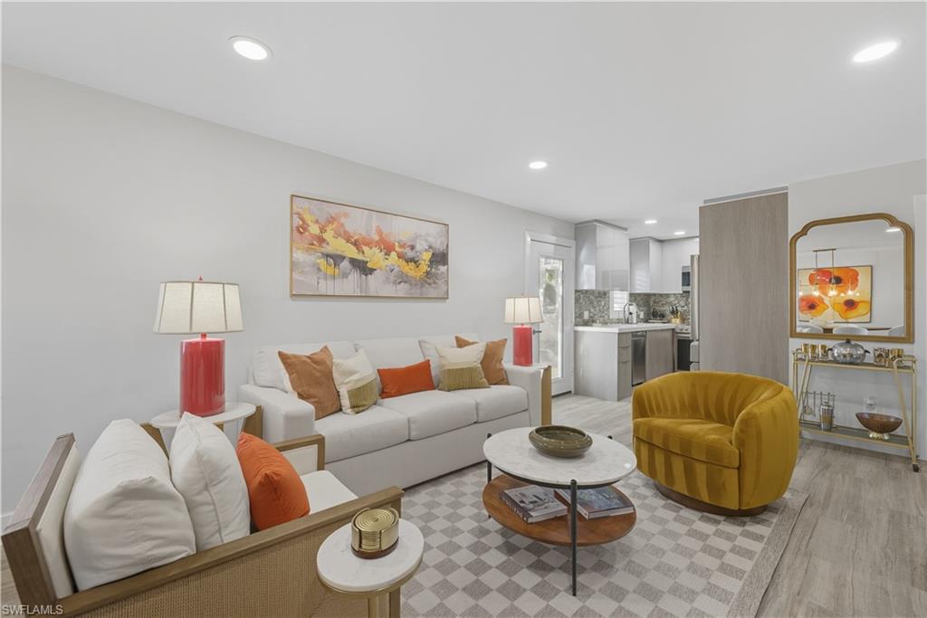 Living area with light wood-style flooring and recessed lighting
