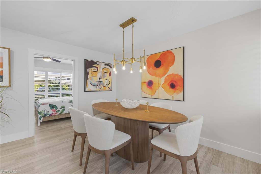 Dining area with light wood-style floors and baseboards