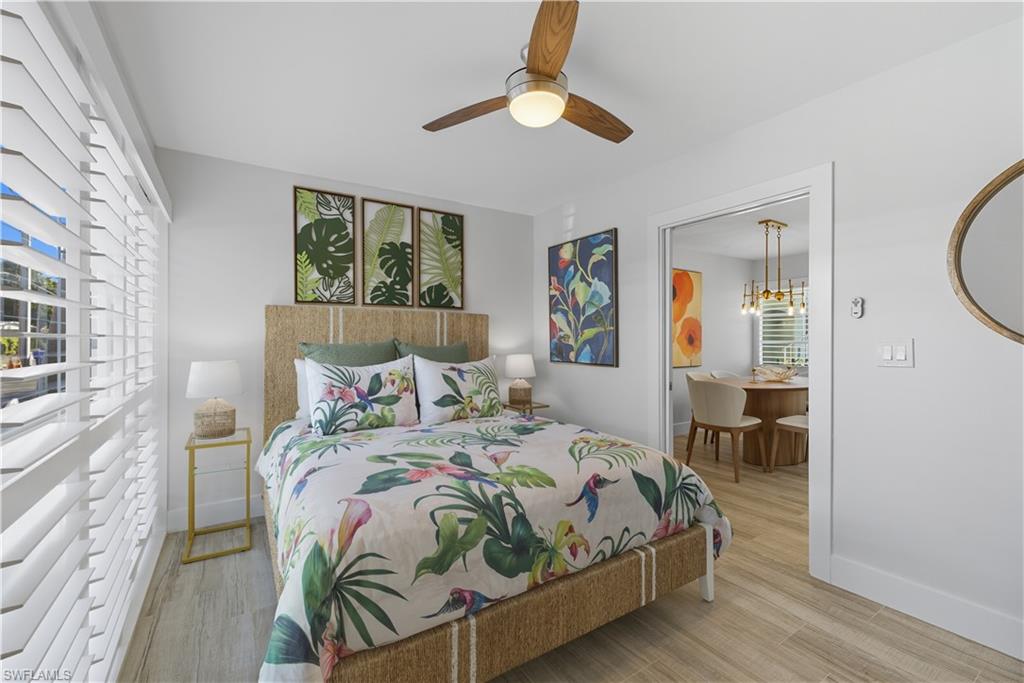 Bedroom featuring light wood-type flooring, ceiling fan, and multiple windows