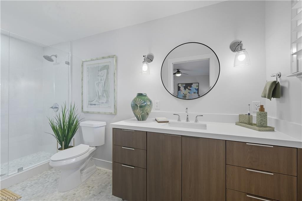 Full bath with vanity, a shower stall, and ceiling fan