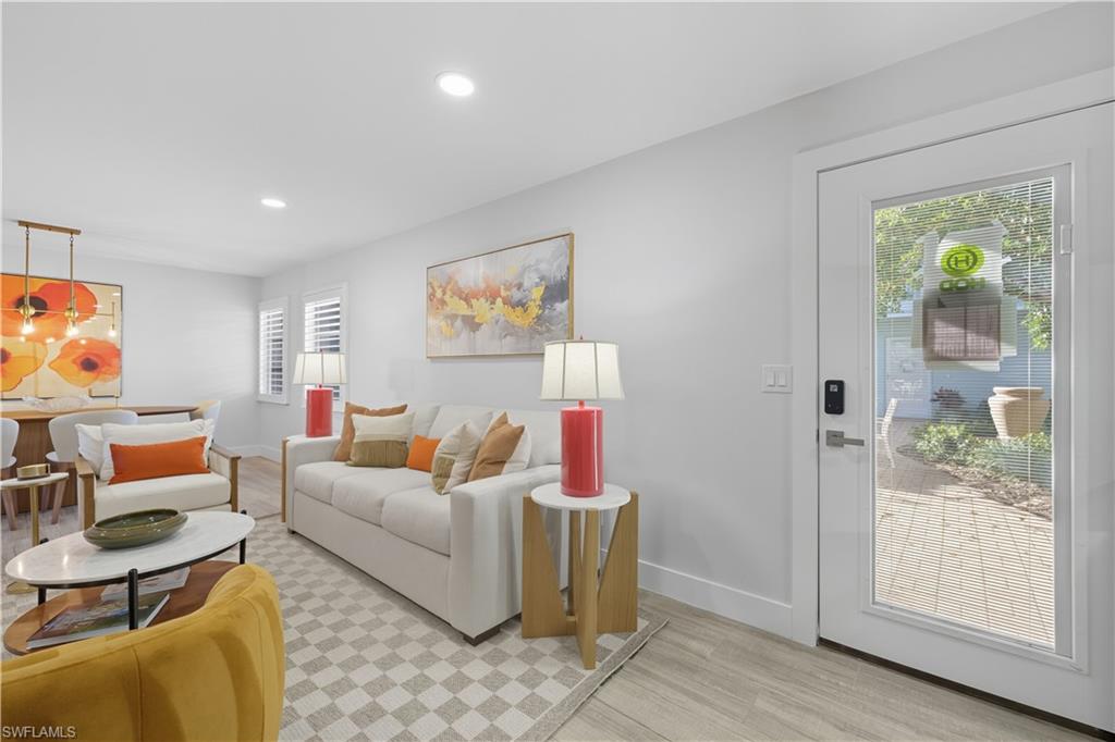 Living room with light wood-style floors and recessed lighting