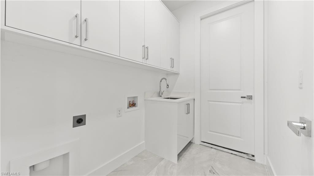 Laundry area with cabinet space, hookup for an electric dryer, and hookup for a washing machine