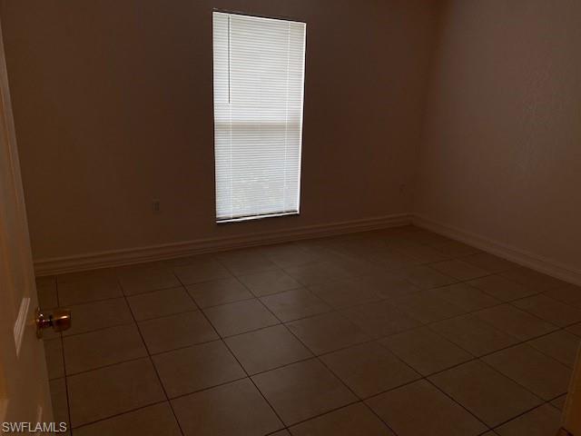 Unfurnished room featuring tile patterned floors