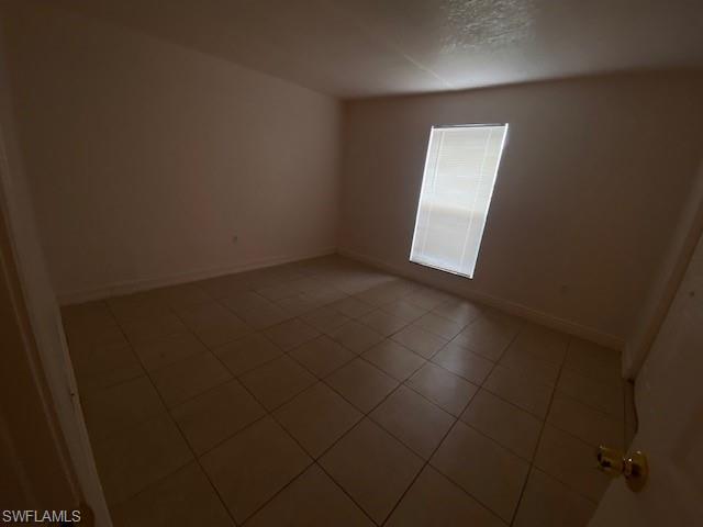 Empty room featuring tile patterned floors