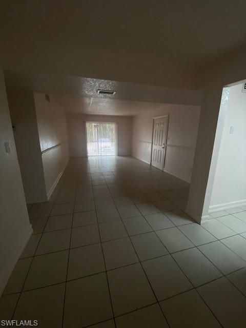 Unfurnished room with light tile patterned floors