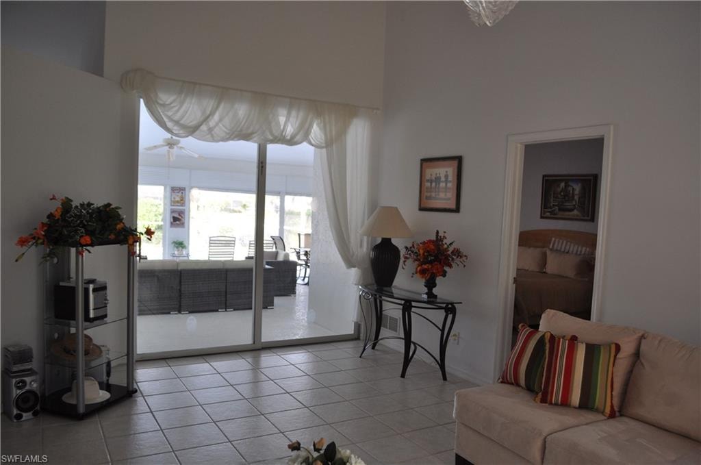 Living area with light tile patterned floors and ceiling fan