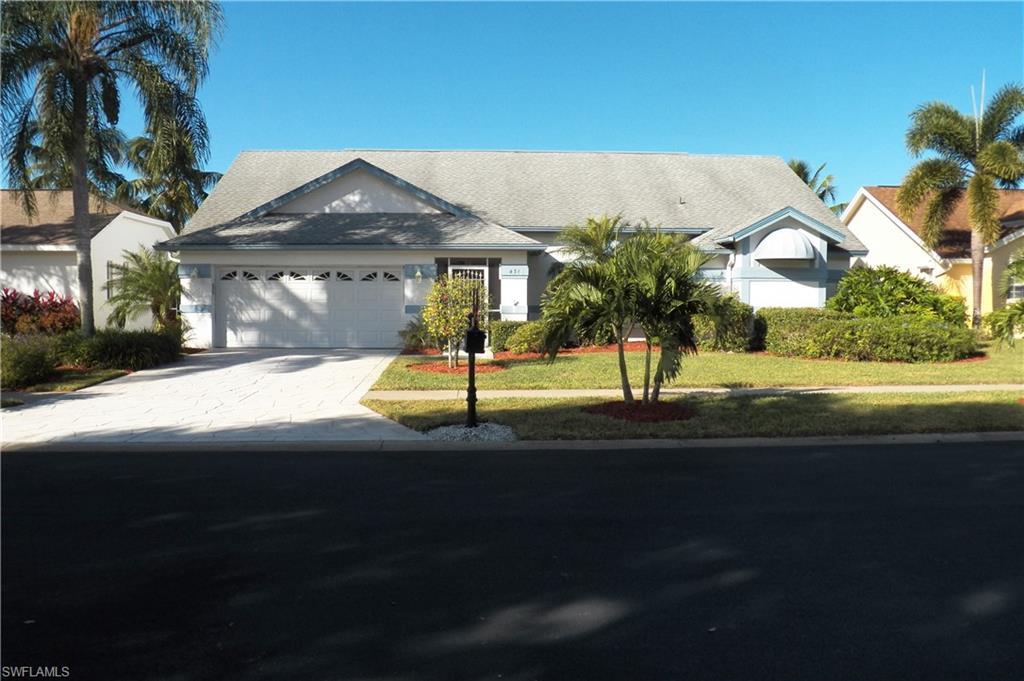 Single story home with driveway, a garage, and a front lawn