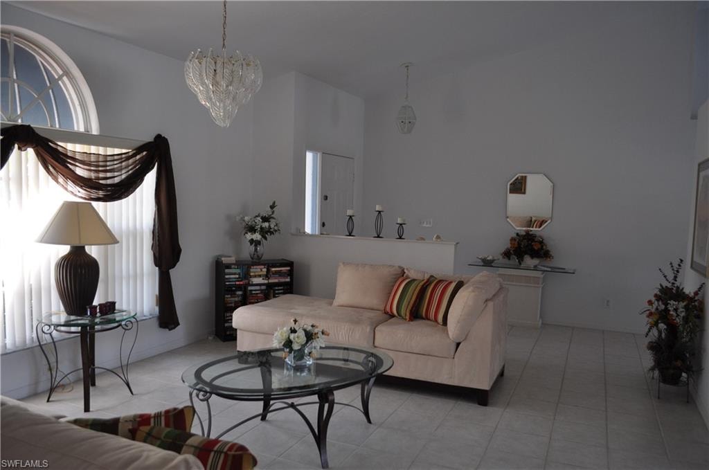 Tiled living area featuring a chandelier