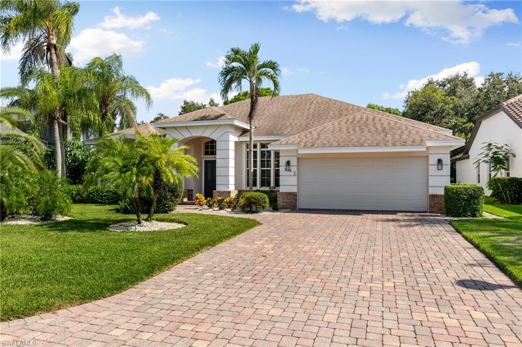 View of front of home featuring a garage and a front yard