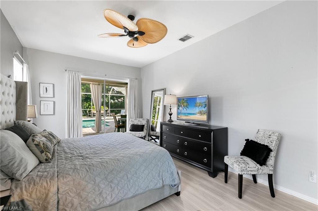 Bedroom with light hardwood / wood-style floors and ceiling fan