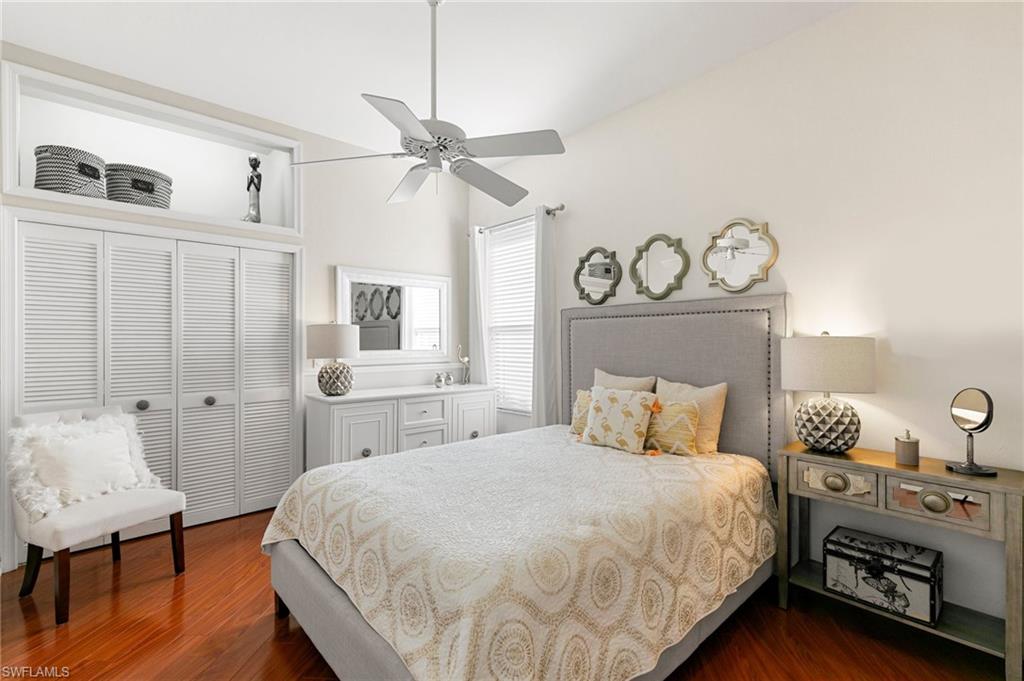 Bedroom with a closet, ceiling fan, and dark wood-type flooring