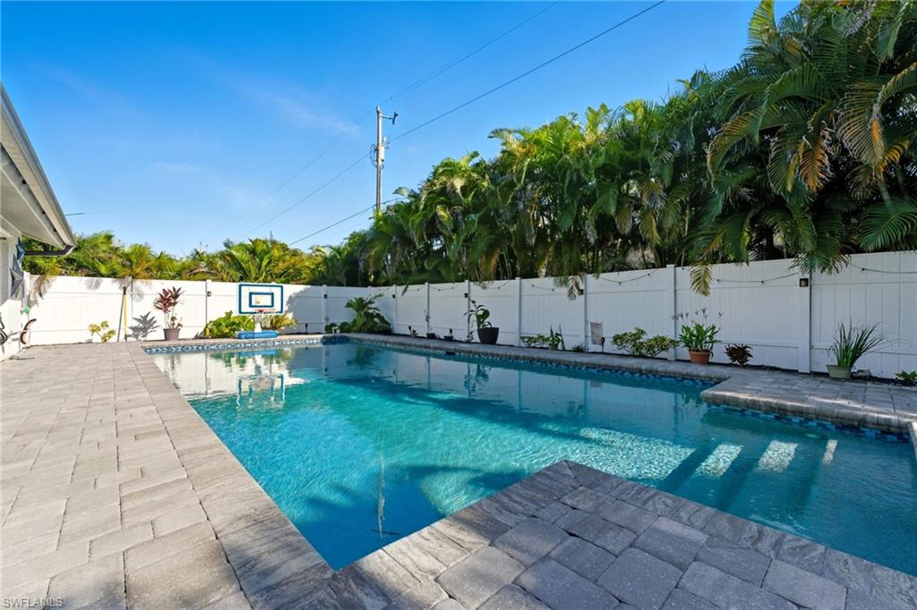 View of swimming pool featuring a patio area and a fenced backyard