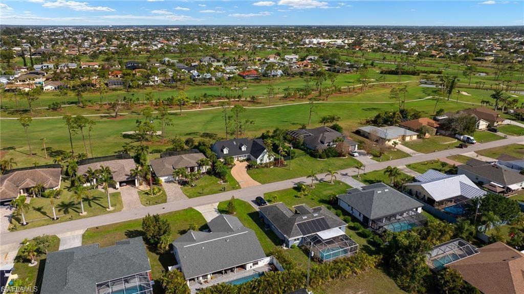 Aerial overview of property's location with a golf club and nearby suburban area