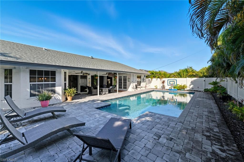 View of swimming pool with a patio, french doors, ceiling fan, and a fenced backyard