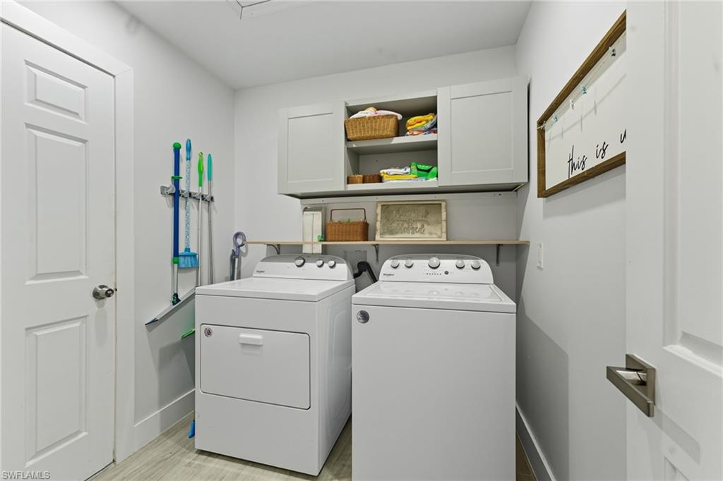 Washroom with cabinet space and separate washer and dryer