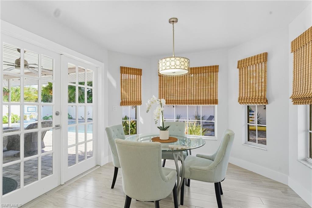 Dining room featuring french doors and light wood-style flooring