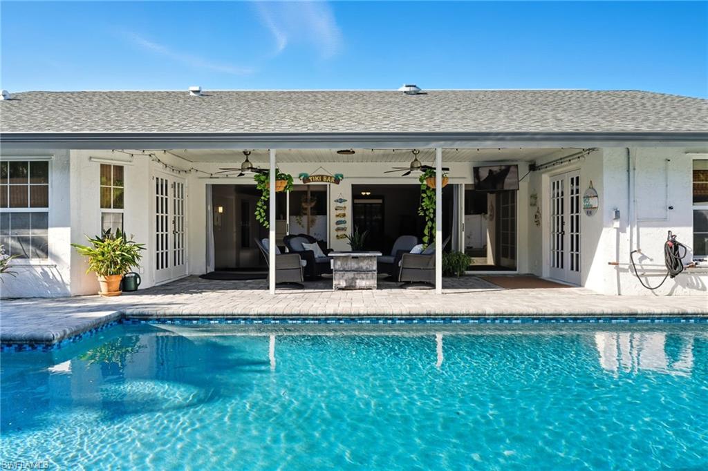 Outdoor pool with french doors, a patio, a ceiling fan, and outdoor lounge area