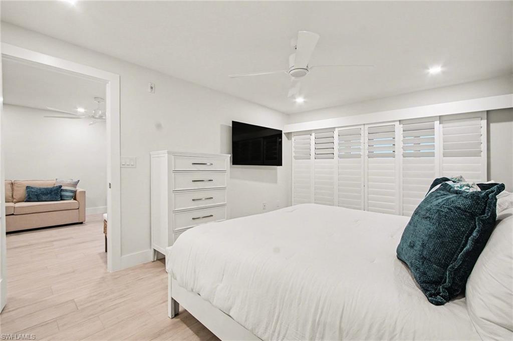 Bright room featuring a ceiling fan with integrated lighting, recessed lighting, and expansive white plantation shutters