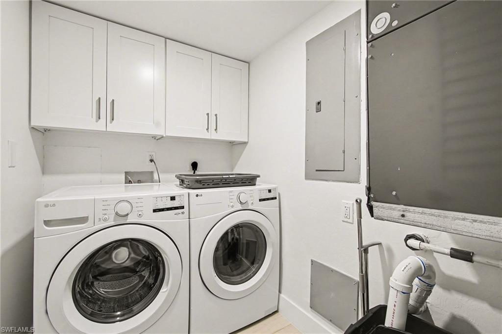 Dedicated laundry area featuring white shaker-style cabinetry, a white countertop, and light-toned flooring