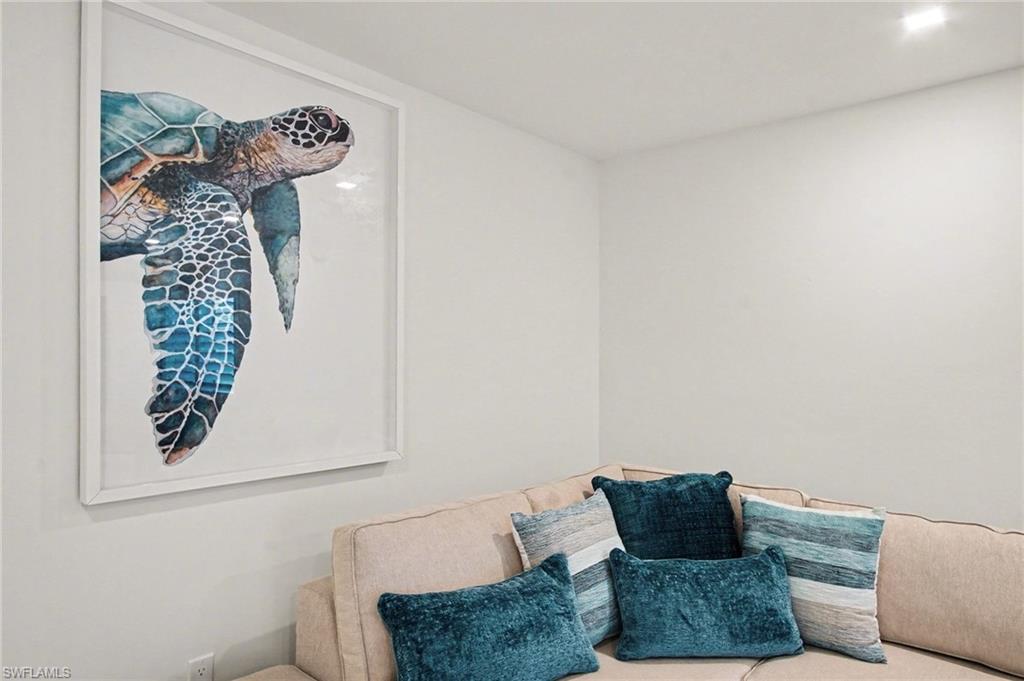 Recessed ceiling lighting illuminates a corner with light-toned walls and a built-in bench seating area