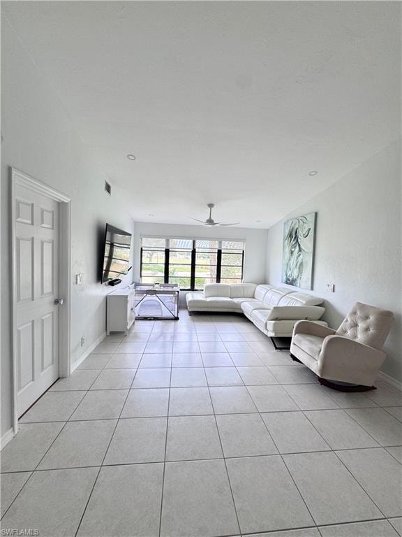 Unfurnished living room with a ceiling fan and light tile patterned floors