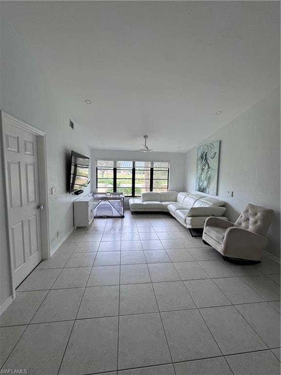 Unfurnished living room with a ceiling fan and light tile patterned floors