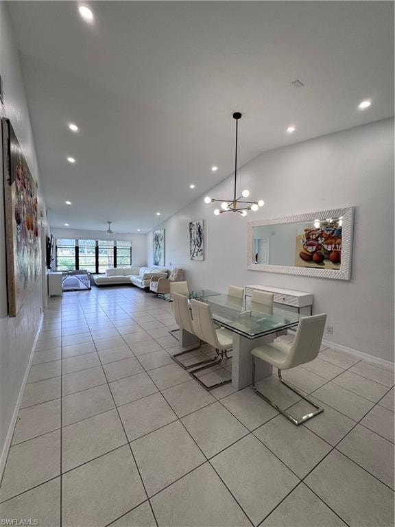 Dining room featuring light tile patterned flooring, vaulted ceiling, and suspended lighting