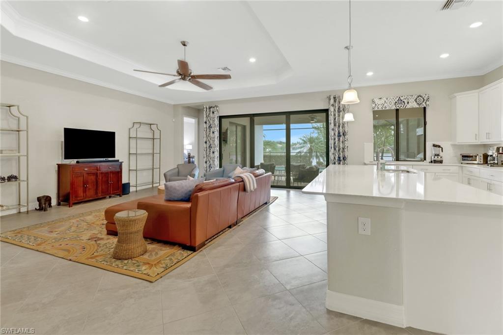 Kitchen open to the great room with lanai leading to the sliding glass doors