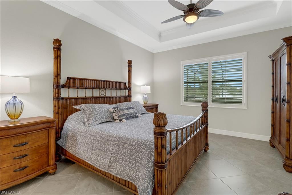 Beautiful primary bedroom with sliding glass door leading to the covered lanai area