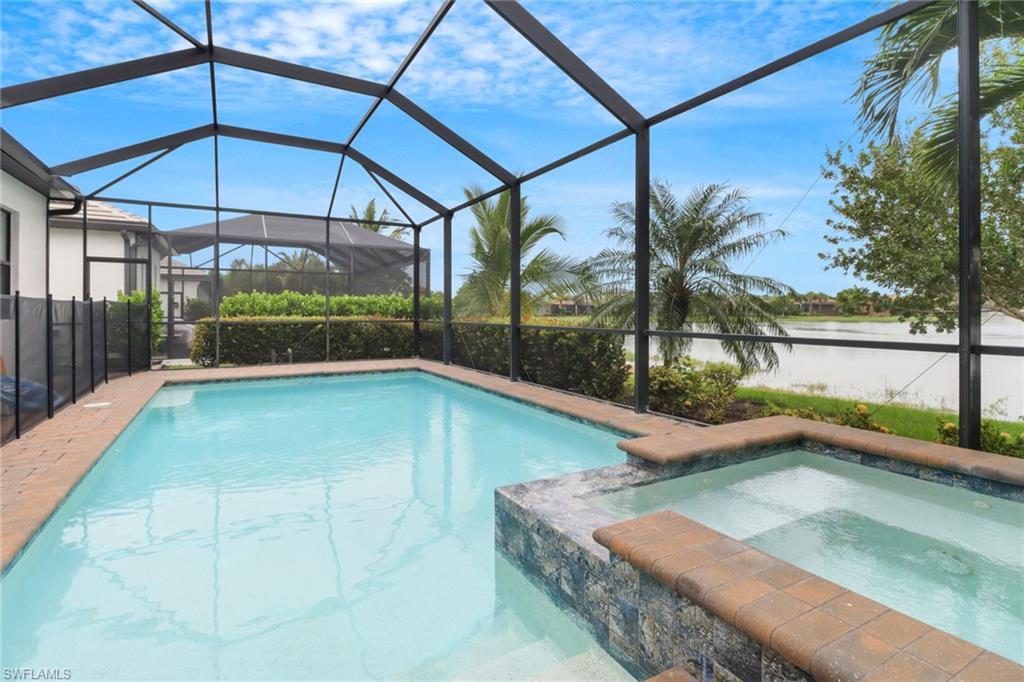 Sparkling swimming pool & spa overlooking the serene lake