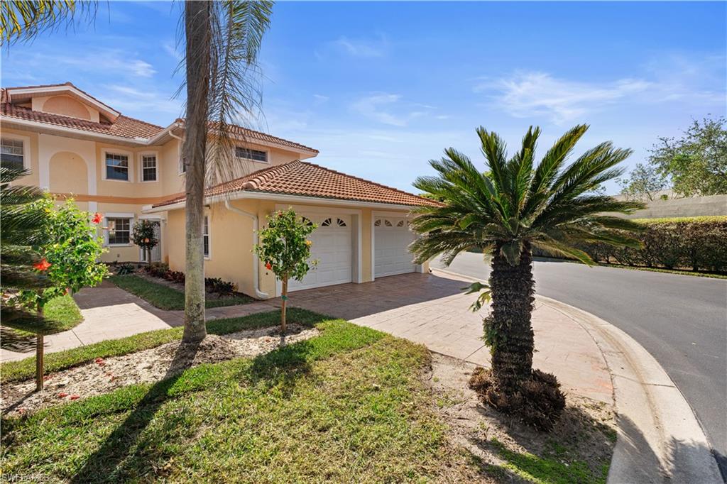 Mediterranean / spanish house featuring stucco siding, a tiled roof, decorative driveway, and a garage