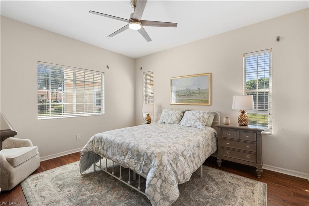 Bedroom with wood finished floors, baseboards, and ceiling fan
