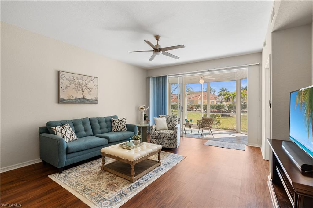 Living area featuring wood finished floors & ceiling fan