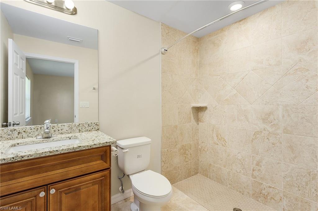Full bathroom with a shower stall and vanity