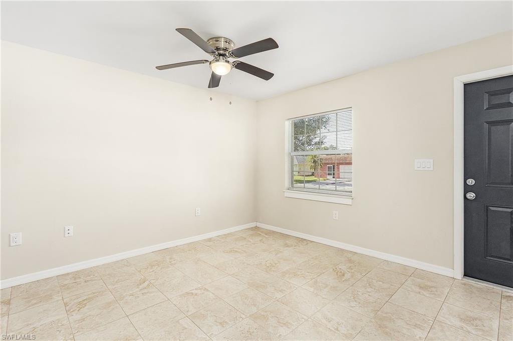 Unfurnished room featuring baseboards and a ceiling fan