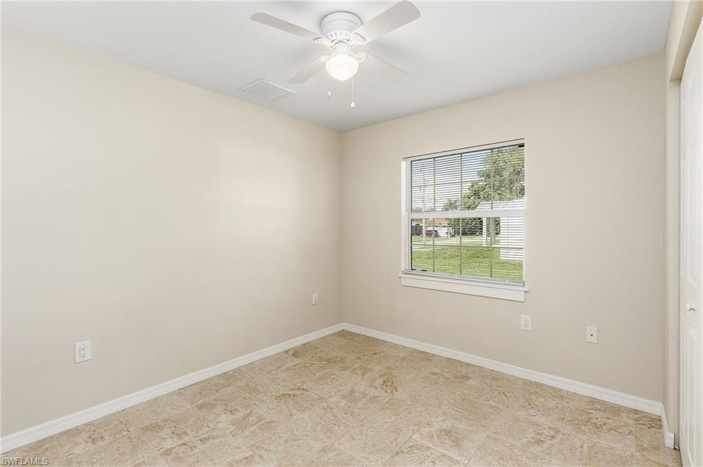 Unfurnished room with baseboards and ceiling fan