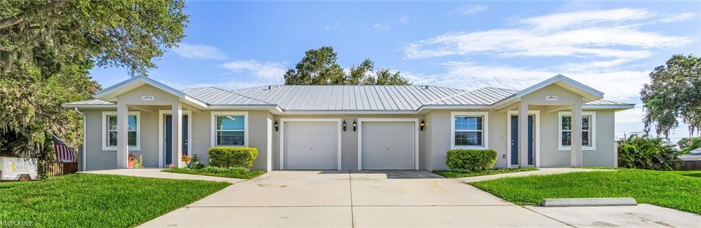 Ranch-style home with a front lawn, stucco siding, and concrete driveway
