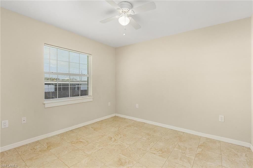 Unfurnished room featuring baseboards and ceiling fan