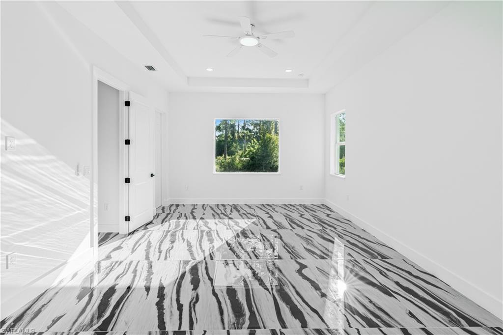 Unfurnished bedroom with baseboards and a ceiling fan