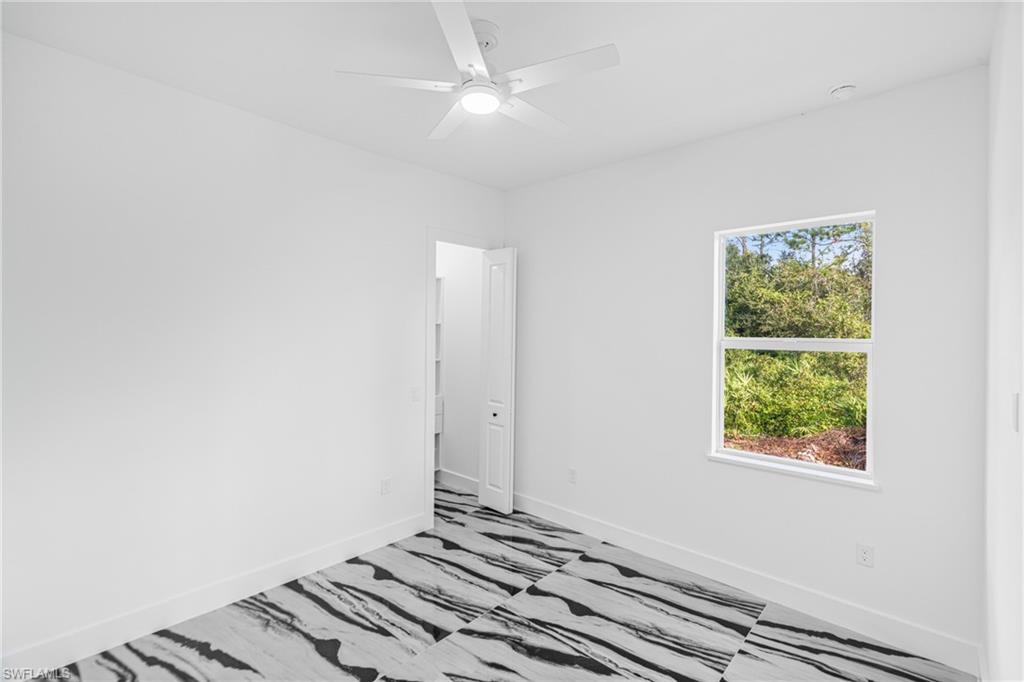 Spare room featuring recessed lighting, a raised ceiling, and a ceiling fan