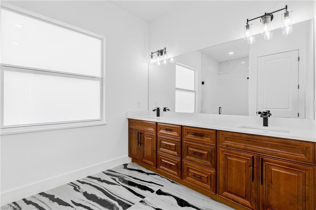 Empty room with a ceiling fan and baseboards