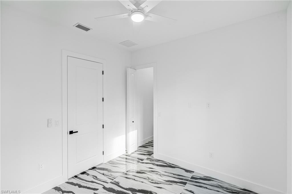 Unfurnished bedroom with a ceiling fan, a tray ceiling, and recessed lighting
