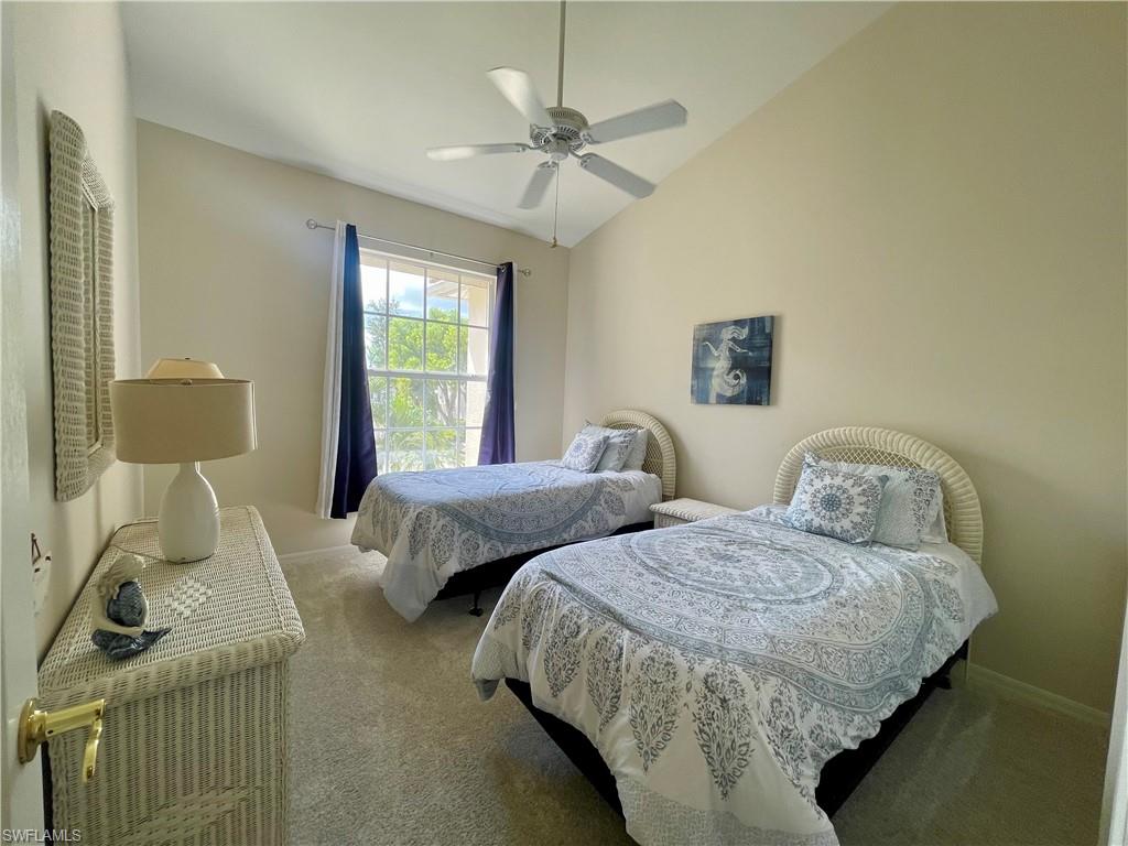 Bedroom featuring vaulted ceiling, carpet floors, and ceiling fan