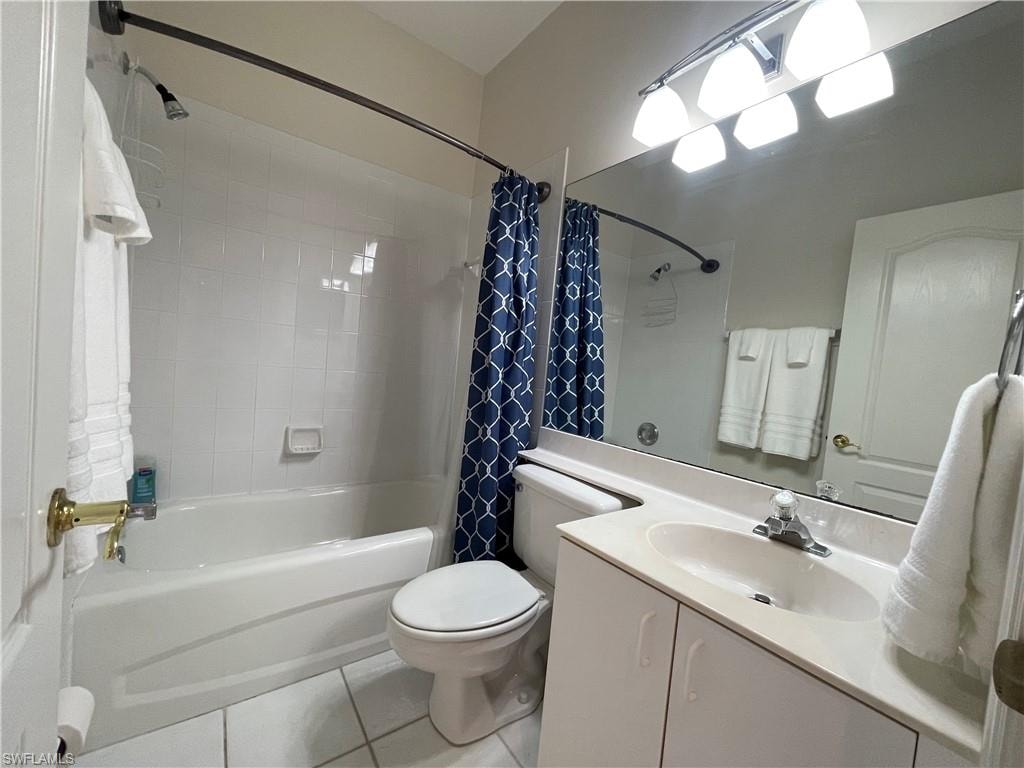 Full bathroom featuring shower / tub combo, vanity, and light tile patterned floors