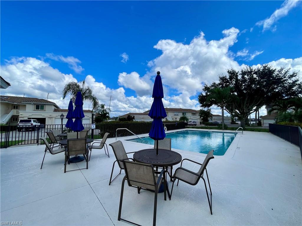 Community pool featuring a patio area and outdoor dining space