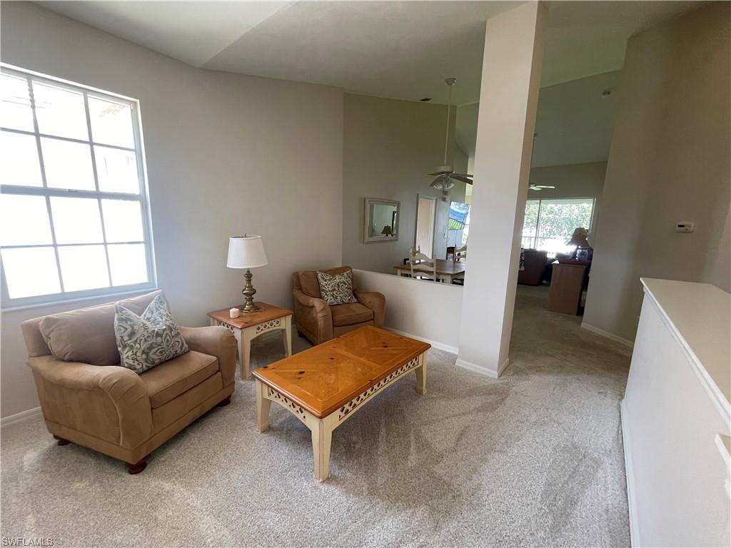 Living room featuring carpet flooring and baseboards