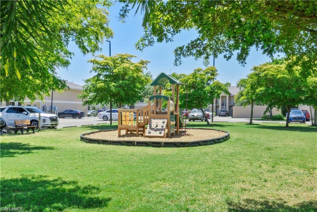 Community jungle gym featuring a lawn